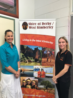 Engagement Officer Lisa with a staff member from Shire of Derby / West Kimberley standing in front of a pull up banner