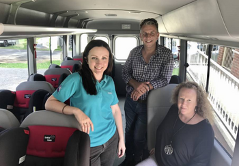 Engagement Officer Caroline Odgers with Bega MP Andrew Constance and Janine Hutt from Campbell page with donated car seats on board Mogo Aboriginal Preschool bus