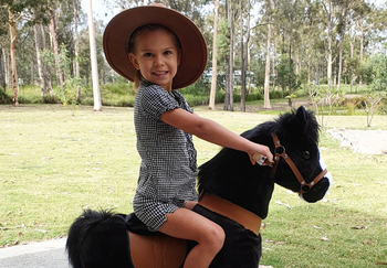 A young girl playing on a pony cycle at Lockyer Valley Community Centre